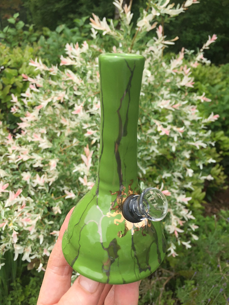 Ancient Creations mini ceramic bubbler bong in clover green, with real gold sunshine design hand painted around the glass bowl.