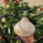 Ancient Creations Ceramics Hookah with two hoses and glass bowl, in white with mother of pearl and gold, in front of a Christmas tree.