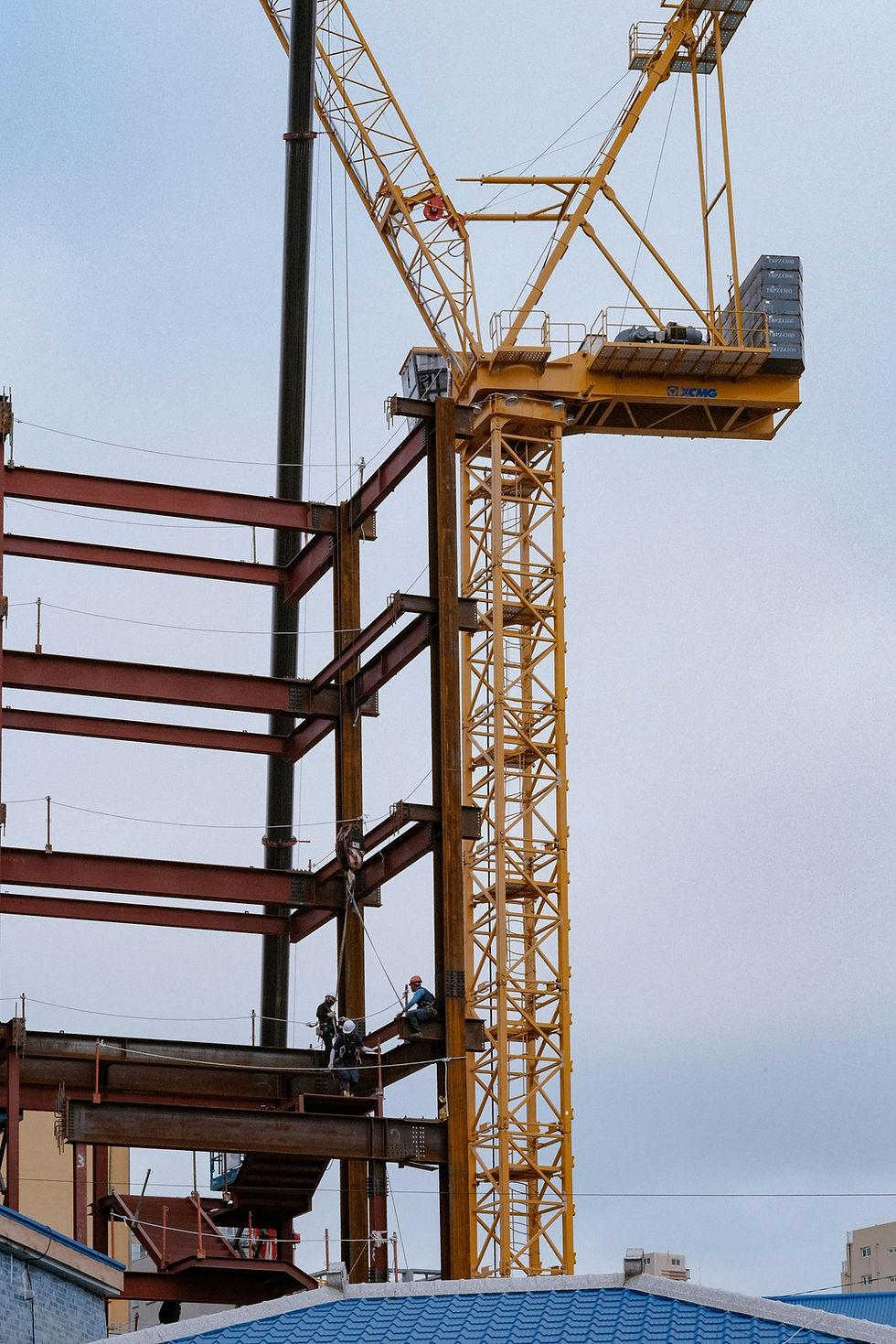 Construction crews assessing a light-rail style  structure and temporary shoring on site