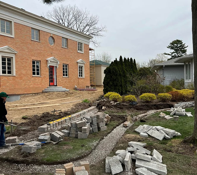 Yard with construction blocks for a retaining wall