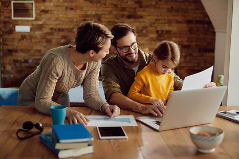 happy-working-father-using-laptop-with-his-family-home (1).jpg