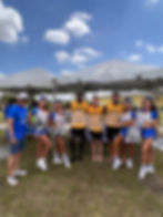 Jimmy Wu, President & CEO, Infinity Air Group, poses with tournament cheerleaders and some of the Spirit Airlines soccer team.