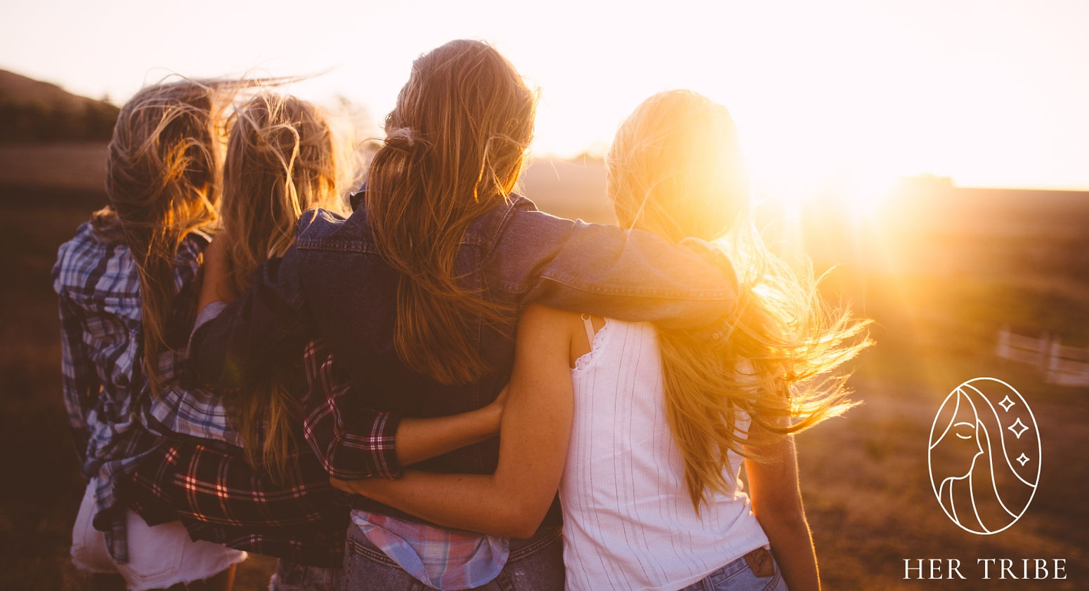 Women with their arms around each other watching the sunset. Creates feelings of support, family, tribe and togetherness.