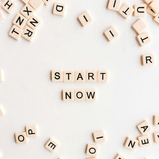 Scrabble letters spelling "start now"
