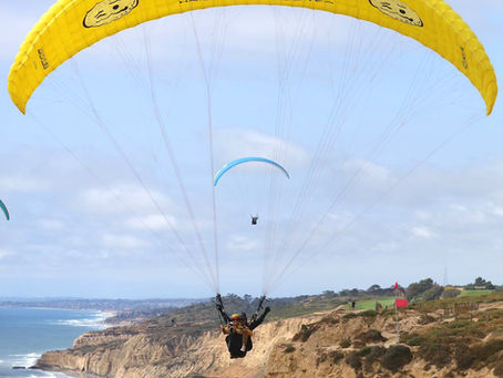 Paraglider flying over the cliffs
