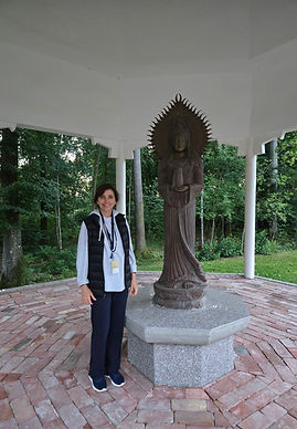 Cindy at ONENESS Noric beside the goddess of compassion statue