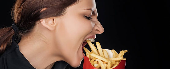 Emotional-woman-eating-tasty-french-fries.jpg
