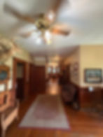 Rustic SC hunting outfitter lodging hallway with deer mounts.