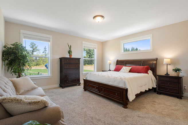 large primary bedroom with rural views