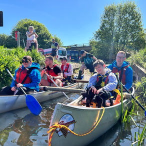 Children and Staff in a canoe on lake.
