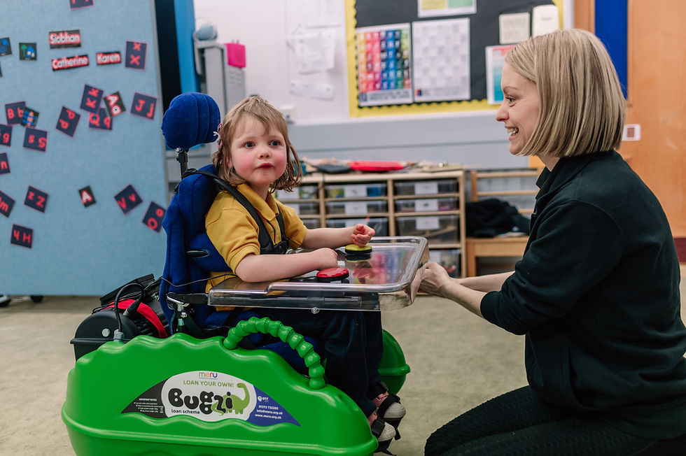 Craighalbert nursery pupil joyfully explores the classroom using a Bugzi mobility vehicle, under the guidance of a one of our Occupational Therapists.