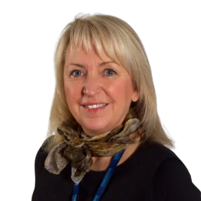 Woman with blond hair smiling at camera