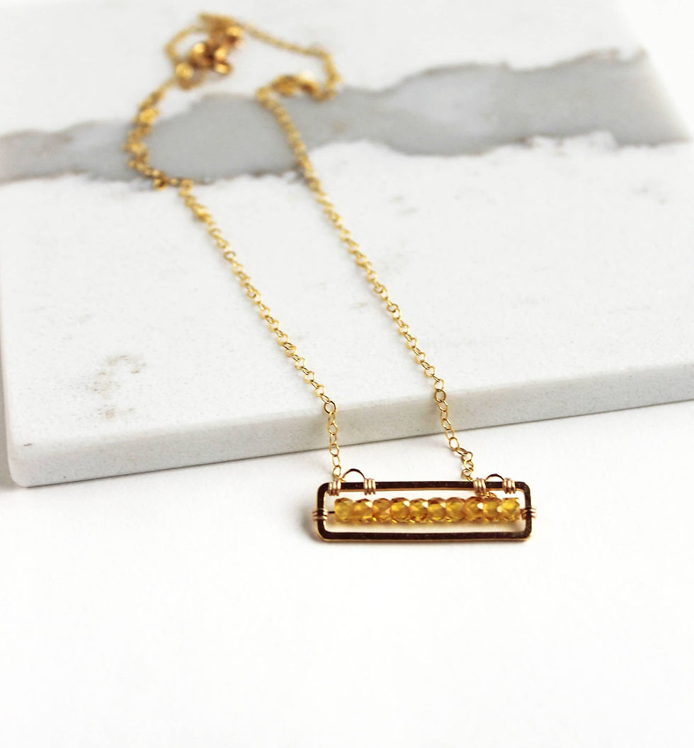 Thumbnail: Delicate gold-filled chain necklace with a rectangular gold finding set with a row of faceted yellow zircon stones.
