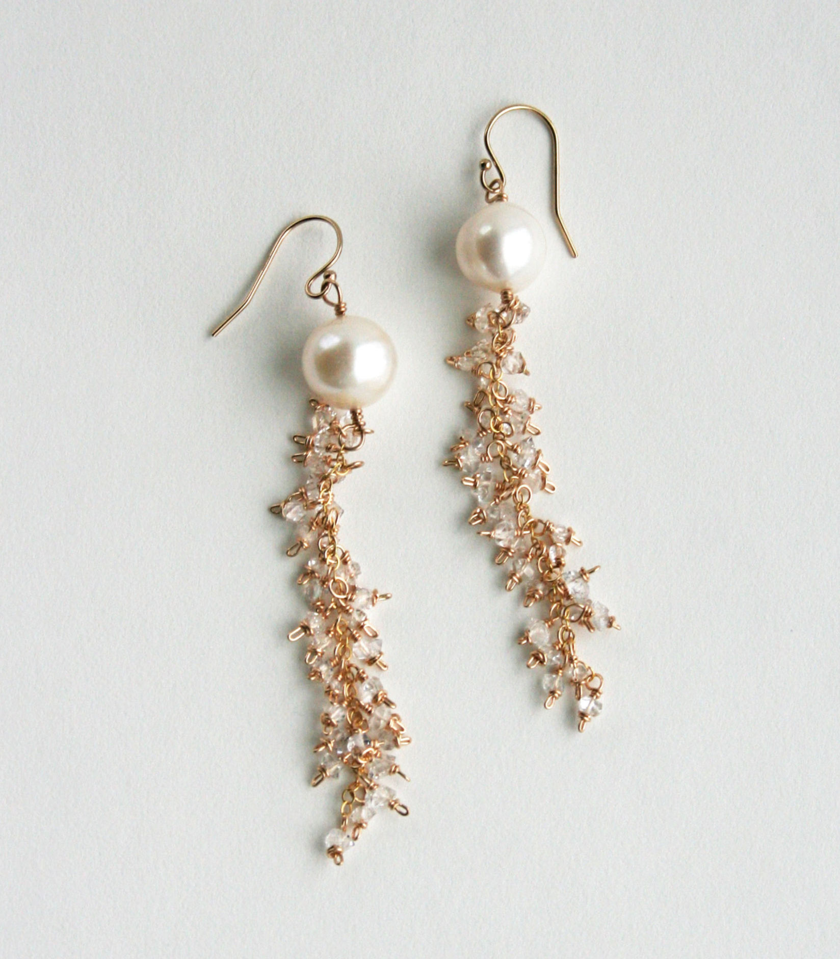 Bridal earrings with a large pearl at the top and long length of chain with crystals.