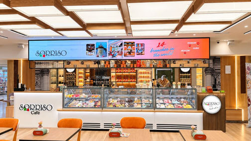 Sorriso café at Metronome Shopping Center in Yerevan, with its gelato counter, wooden tables and orange chairs.
