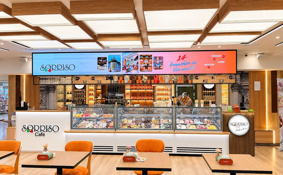 Sorriso café at Metronome Shopping Center in Yerevan, with its gelato counter, wooden tables and orange chairs.