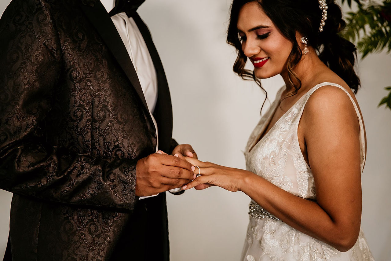 Bride and groom exchanging rings