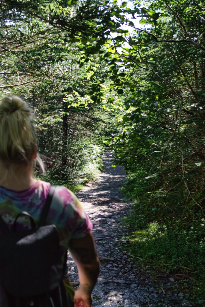 Woman hiking the La Manche Village Path, East Coast Trail