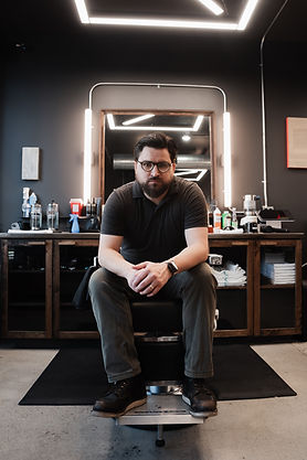 Kaizen Barber Blaze sitting in chair