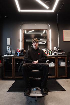 Nash, texture hair specialist sitting in chair