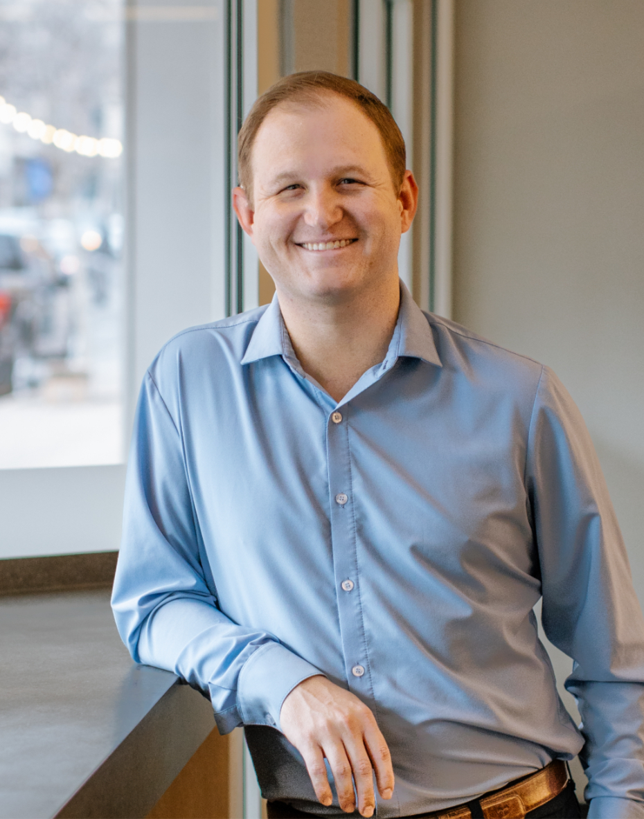 Heavily tattooed leader laughing over collaboration