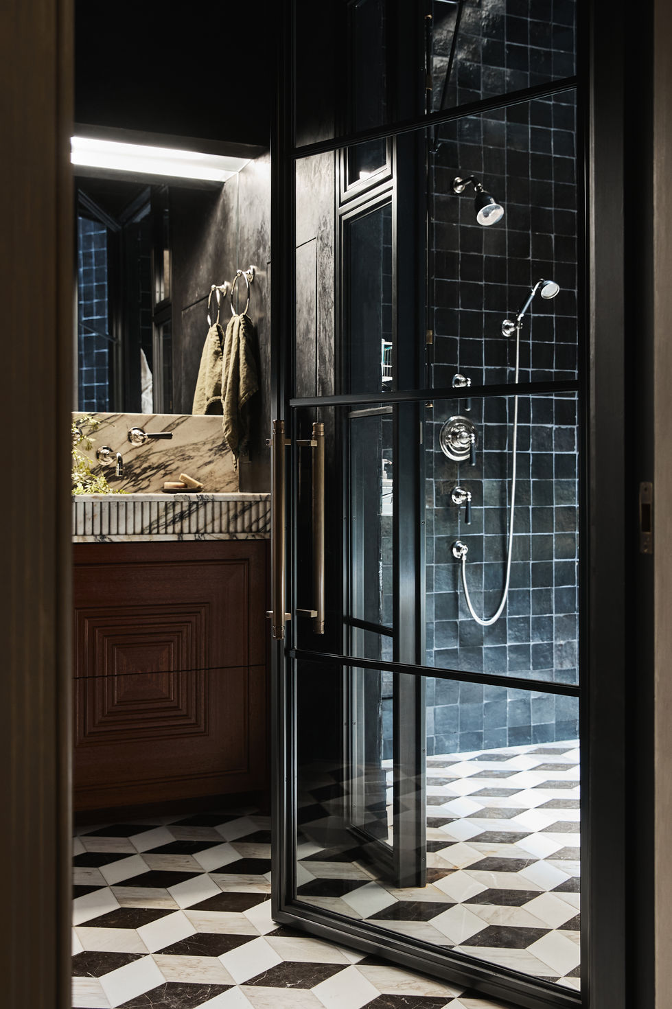 Our Chelsea Project main bath wet room with an Amuneal Frankford series door. The walls are Cle Tile Charred Cedar zellige and the fixtures are from The Water Monopoly Soho collection.