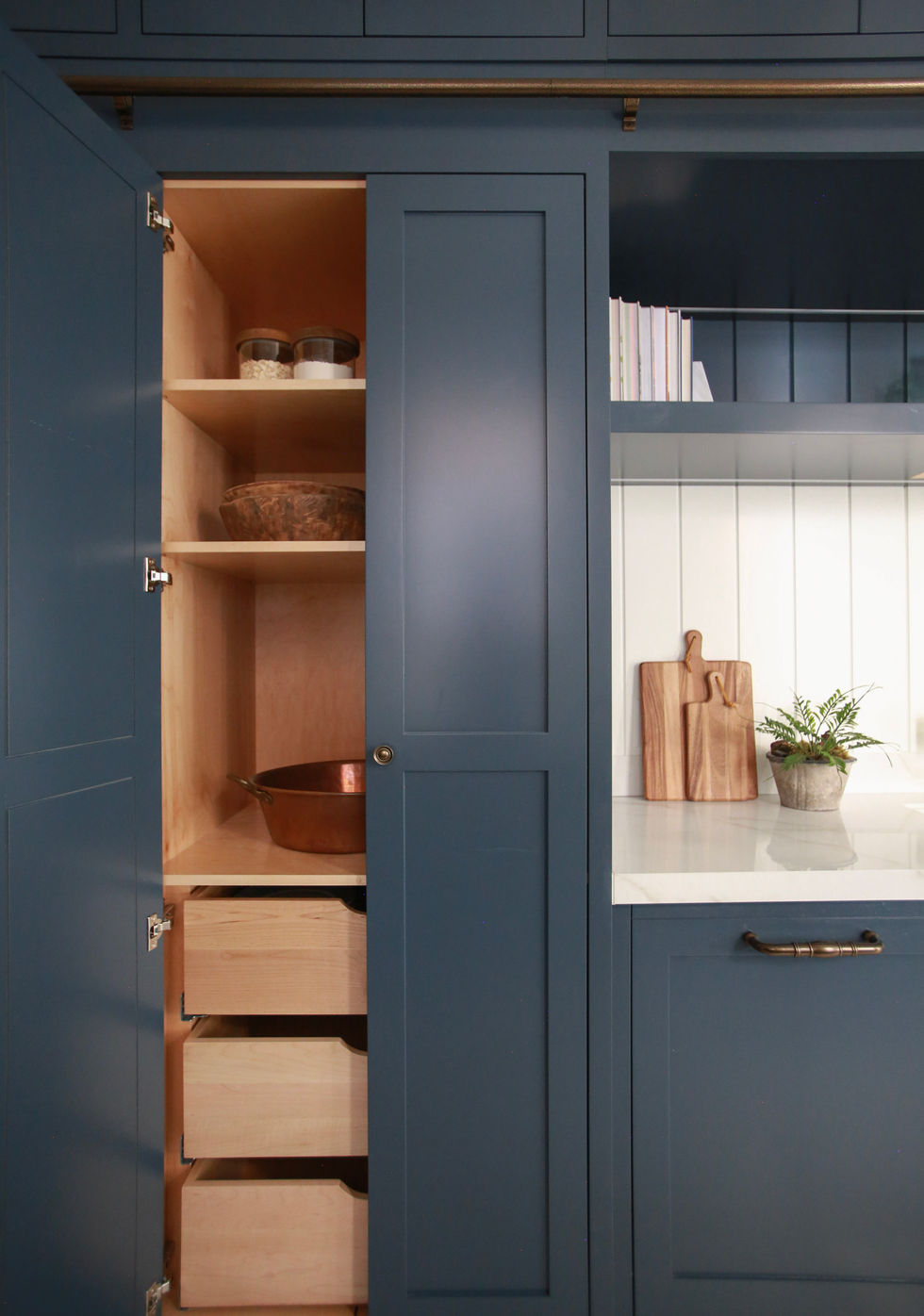 Our Corinthian Project kitchen pantry cabinet and panelled dishwasher. The cabinets are Farrow & Ball Hague Blue.