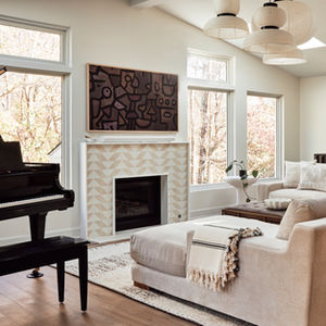 Our Wynnewood Project living room with a fireplace surround in Zia Tile Press Play and Formakami lantern pendants.