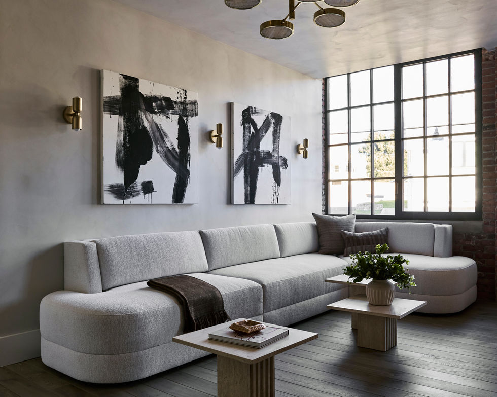 Our Westport Project Lounge with a custom sofa upholstered in Kravet boucle. The walls and ceiling are Portola Lime Wash Classic Gray and the cocktail tables are travertine. The chandelier is a Sistema Solare and the sconces are from In Common With.