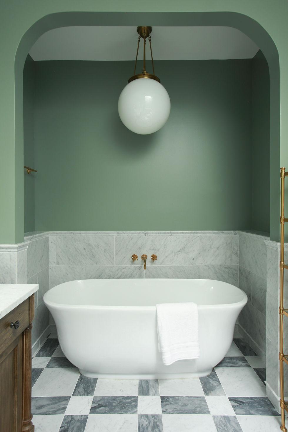 Our Corinthian Project main bath with an RH tub filler and pendant by Rejuvenation. The walls are painted Farrow & Ball Card Room Green and the floors are Carrara and Bardiglio marble.