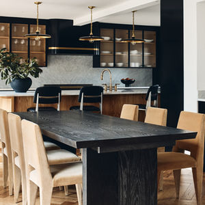 Our Moorestown Project kitchen and dining area with oak herringbone parquet floors. The counters and backsplash are Carrara marble and the pendants are Visual Comfort.