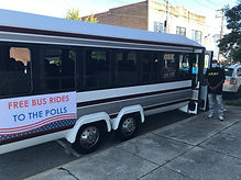 A Democratic Women of North Carolina bus with the sign "Free Bus Rides to the Polls" on it