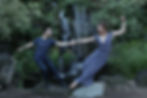 West Coast Swing dancers on rocks in front of a waterfall. Rebecca ludwick and Nicolas Bourgeais modern swing partners in nature .