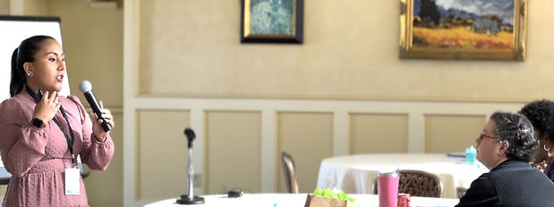 Andrea is speaking at a conference.