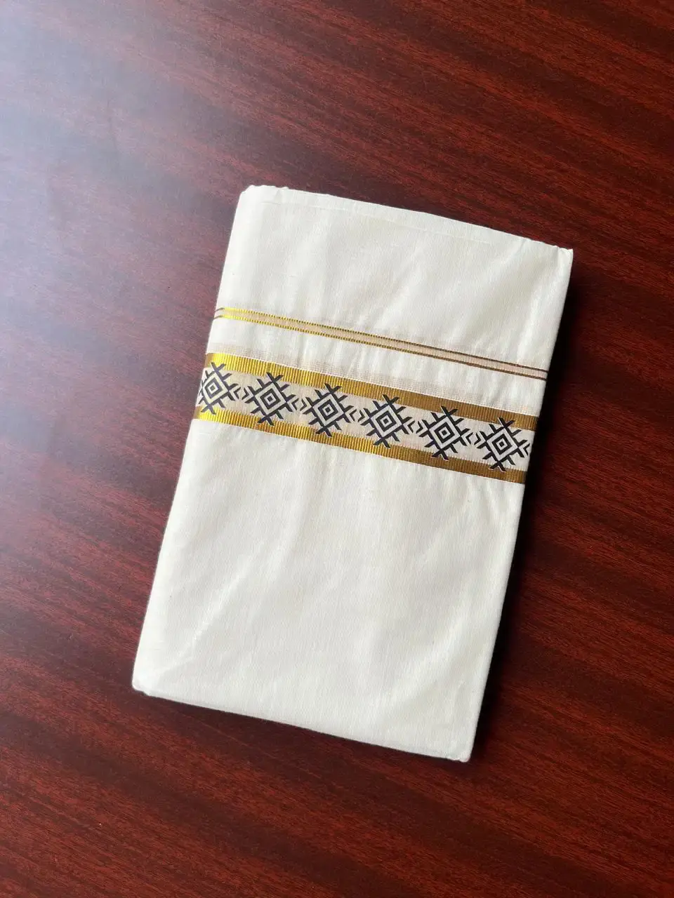 Black geometric Motif Hand-Painted Golden Kasavu Double Mundu image folded view