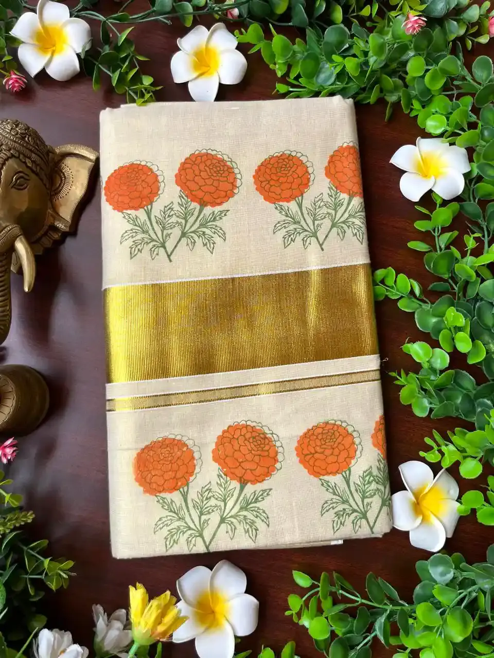 Mari Gold Floral Motif Tissue Kerala Kasavu Saree image folded view