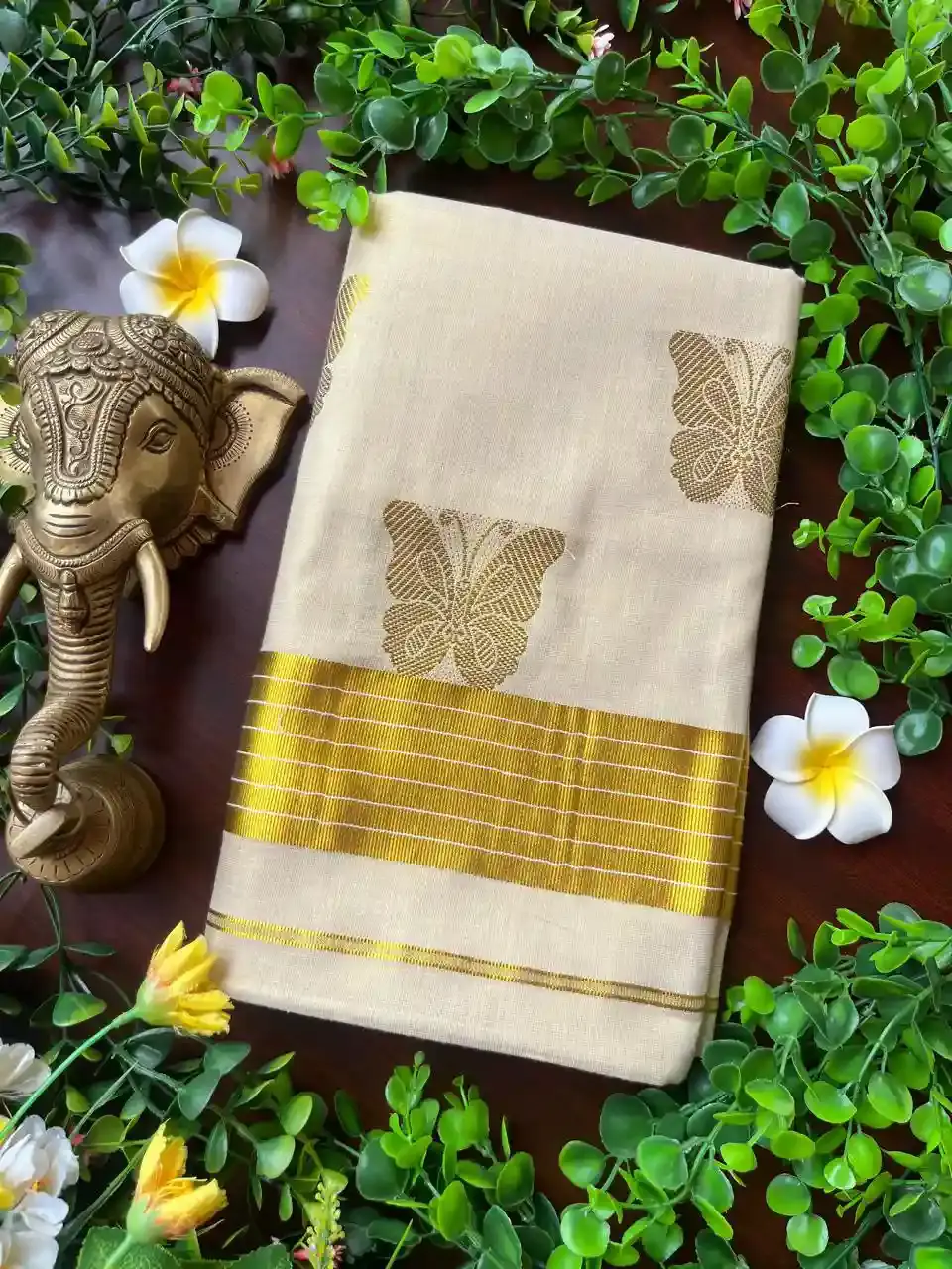 Thumbnail: Golden Butterfly Jacquard Tissue Kerala Kasavu Saree image folded view