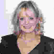 Picture of Twiggy today, smiling, with longer hair, and a little more weight.