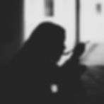 A silhouette of a person eating