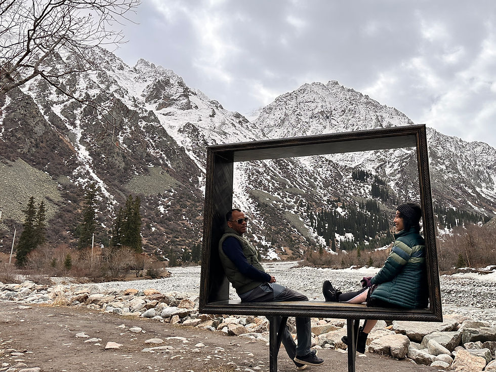 Sarmin & Bhaar enjoys a unique photo opportunity, framed against the breathtaking snow-capped mountains of Ala Archa National Park, Kyrgyzstan.