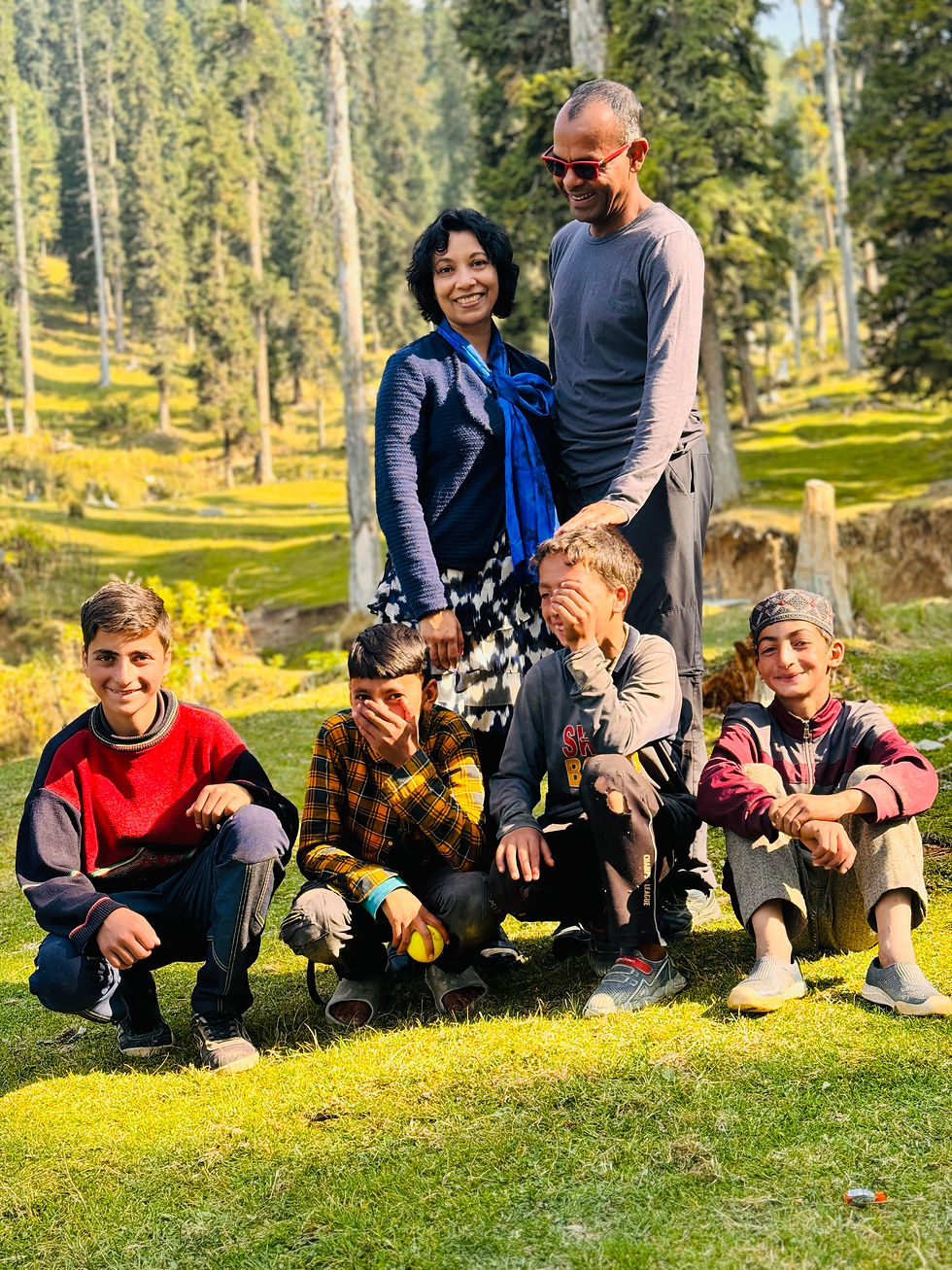Bahar and Sarmin enjoying a sunny day in the lush landscapes of Kashmir with a group of cheerful children.