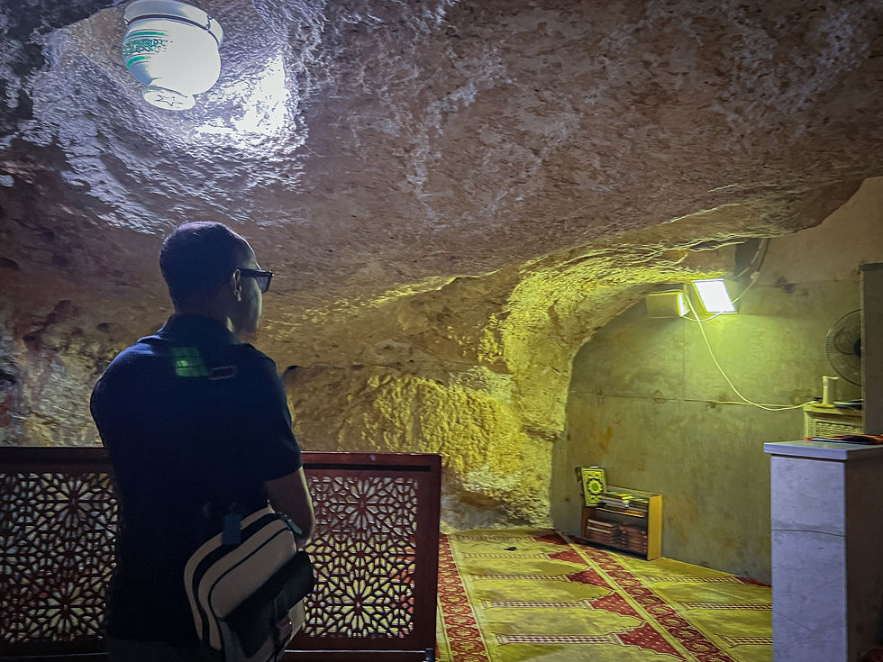 Bahar stands inside the sacred cave beneath the rock, located in the Al Aqsa Mosque, a site of deep spiritual significance where believers hold that souls will gather on the Day of Judgment.