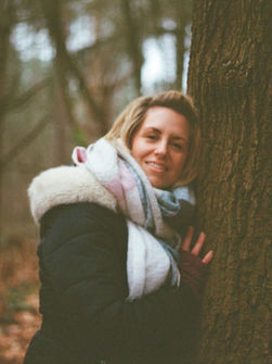 Woman hugging a tree in Winter
