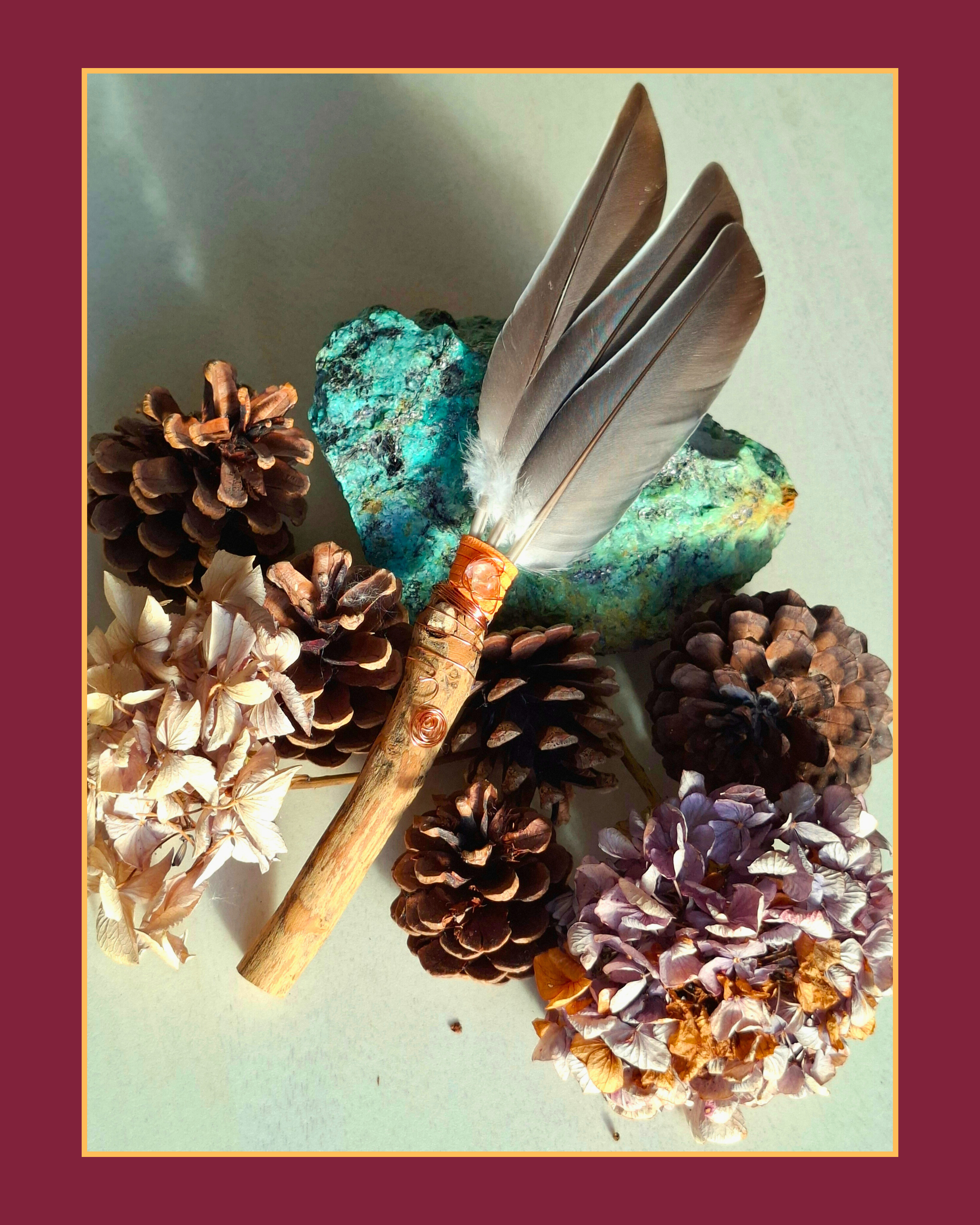 A small e feathered pigeon wand in orange wrap.