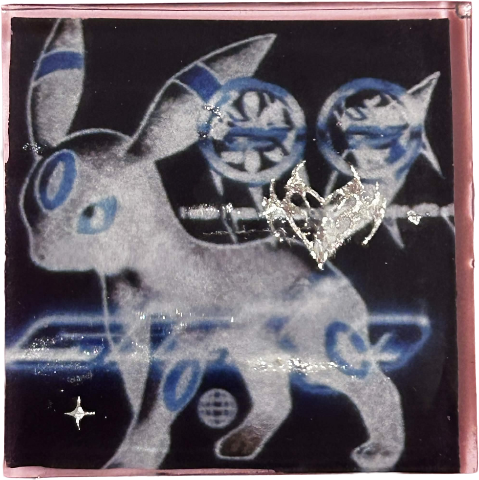 product photo of resin magnet with an image of a blue umbreon with a black background and silver embelishments