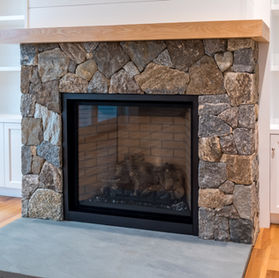 Stone fireplace with wood mantel 