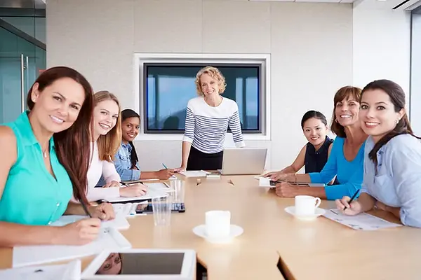 women-in-meeting-smiling.webp