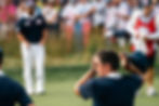 Golfer with hands on head on the green