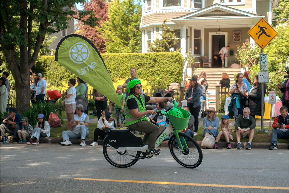 Person riding a Lime eBike in the 2025 Hyack Multicultural Parade