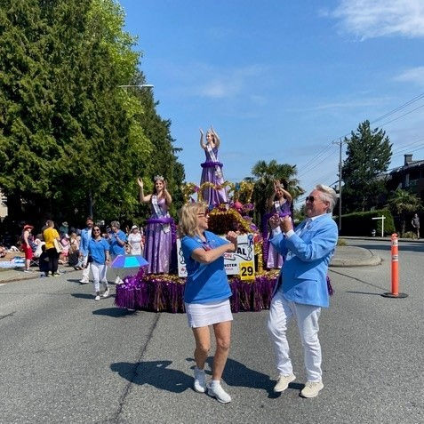 two people high-fiving in front of the Hyack Festival Float